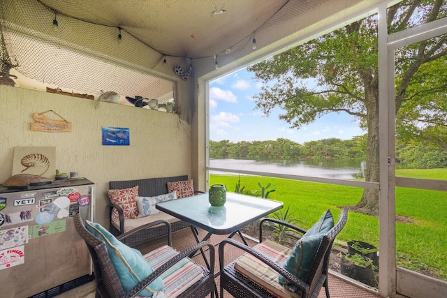 sunroom / solarium with a water view