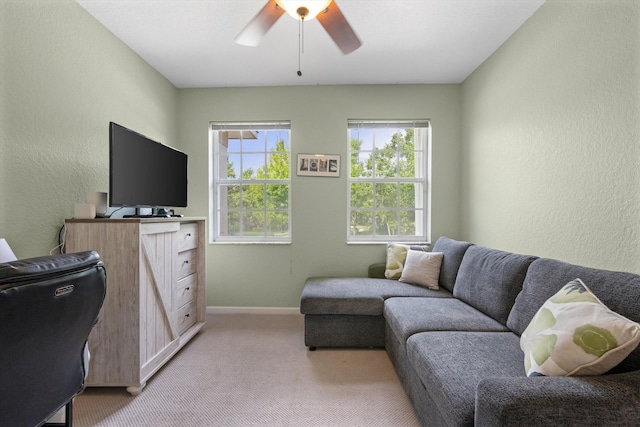 carpeted home office featuring ceiling fan