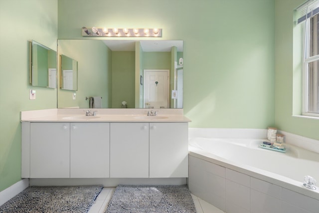 bathroom with tile patterned floors, vanity, and a healthy amount of sunlight