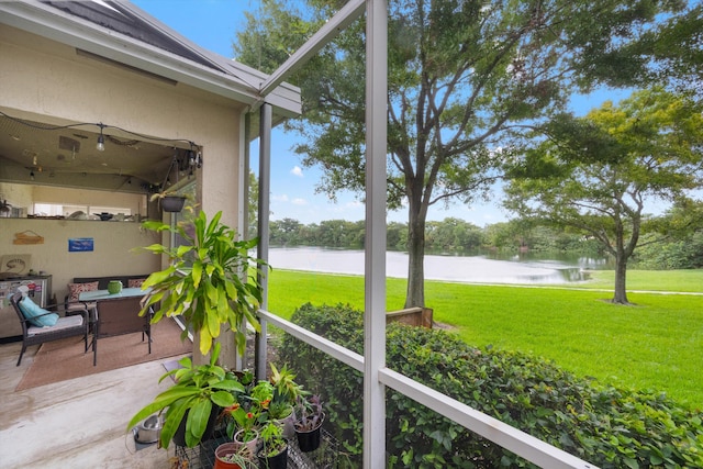 sunroom featuring a water view