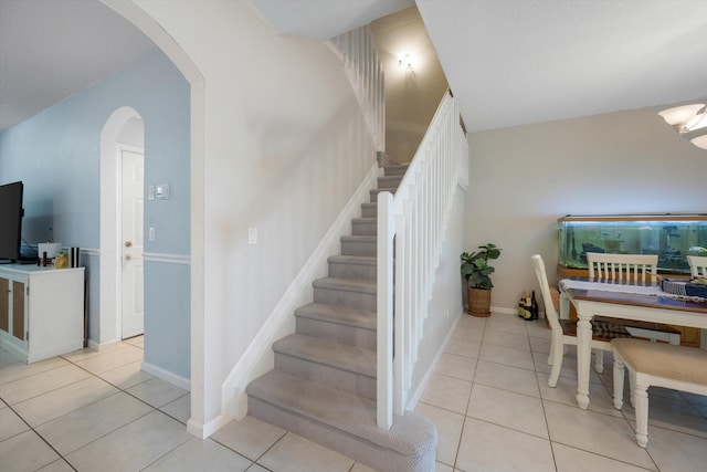 stairway with tile patterned floors