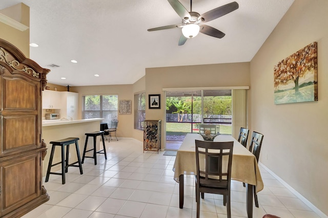 tiled dining space featuring ceiling fan