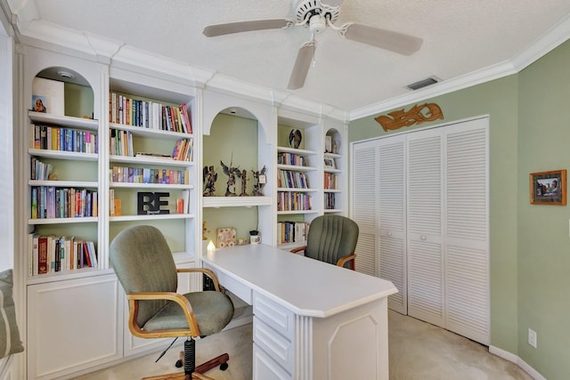 carpeted home office featuring a textured ceiling, ornamental molding, and ceiling fan