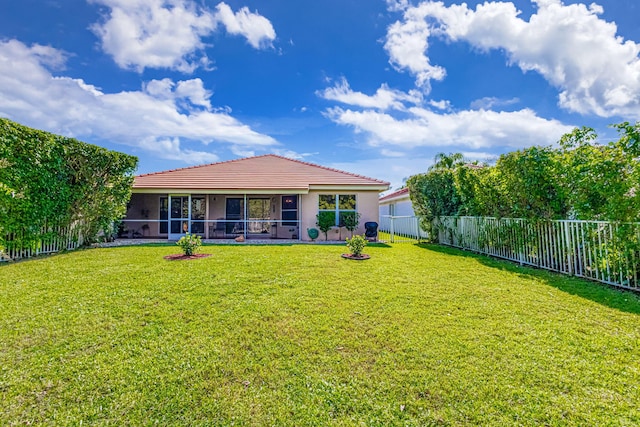 rear view of property with a lawn