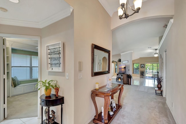 corridor featuring crown molding, vaulted ceiling, light colored carpet, and a notable chandelier