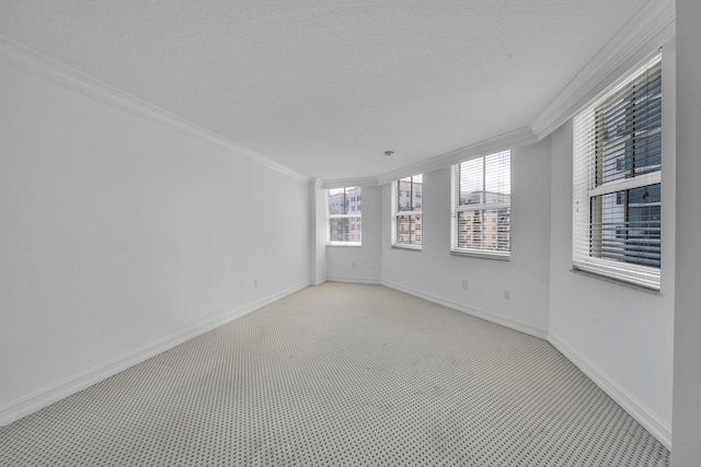 carpeted empty room featuring a textured ceiling and ornamental molding