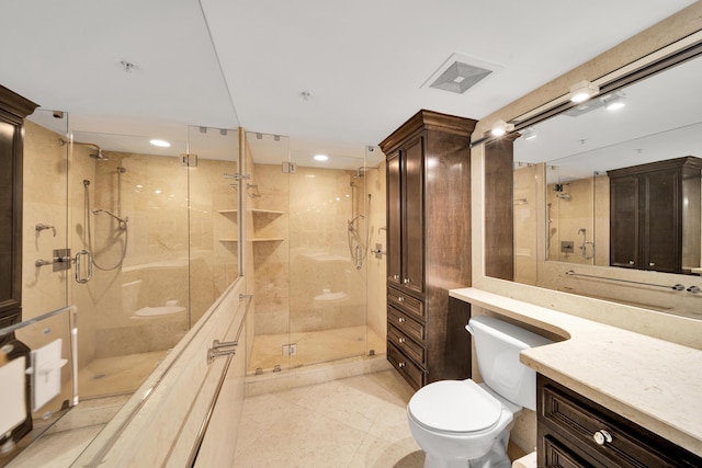 bathroom with tile patterned flooring, walk in shower, vanity, and toilet