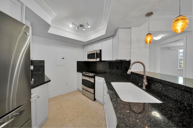 kitchen with pendant lighting, stainless steel appliances, sink, and white cabinetry