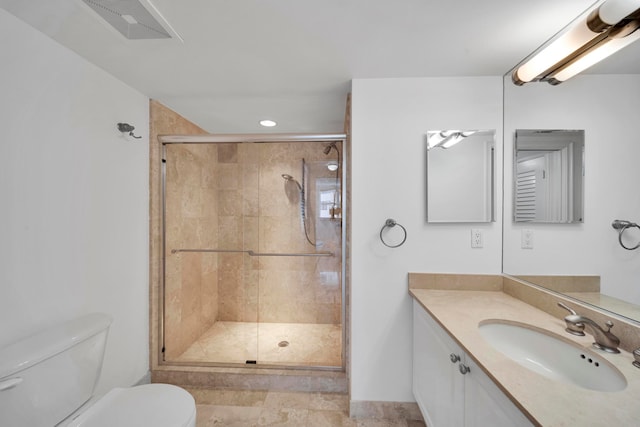 bathroom featuring walk in shower, vanity, and toilet