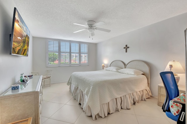 bedroom featuring ceiling fan, a textured ceiling, and light tile patterned flooring