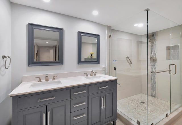 bathroom featuring walk in shower and vanity