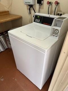 laundry area with water heater and washer and dryer