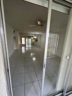 hall with tile patterned floors