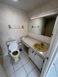 bathroom featuring tile patterned flooring, vanity, and toilet