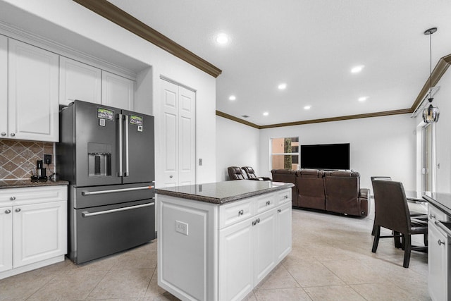 kitchen with light tile patterned floors, tasteful backsplash, a kitchen island, stainless steel fridge with ice dispenser, and white cabinetry