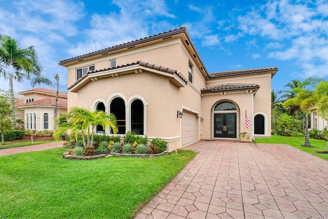 back of property featuring a garage and a yard