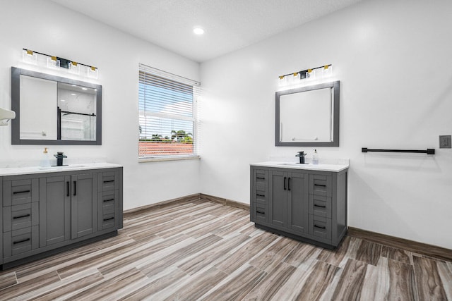 bathroom featuring vanity, a textured ceiling, and hardwood / wood-style flooring