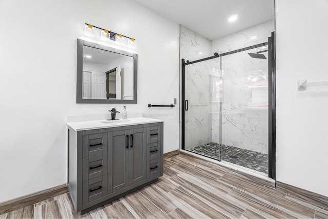 bathroom featuring vanity and a shower with door