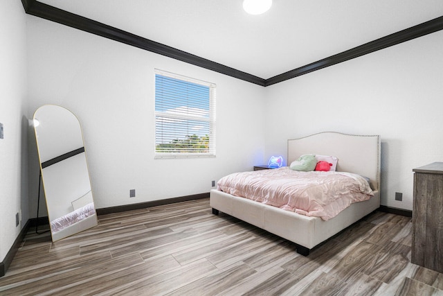 bedroom featuring crown molding and hardwood / wood-style floors