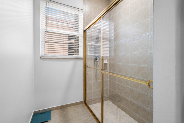 bathroom with a shower with door