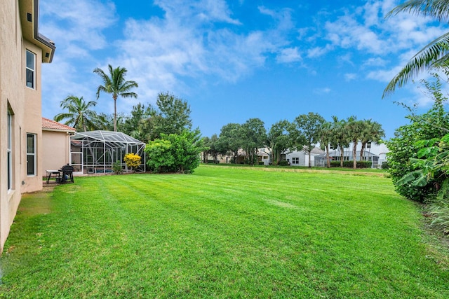 view of yard with glass enclosure