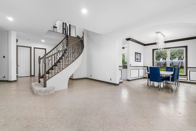 dining room with light tile patterned floors, a chandelier, and ornamental molding