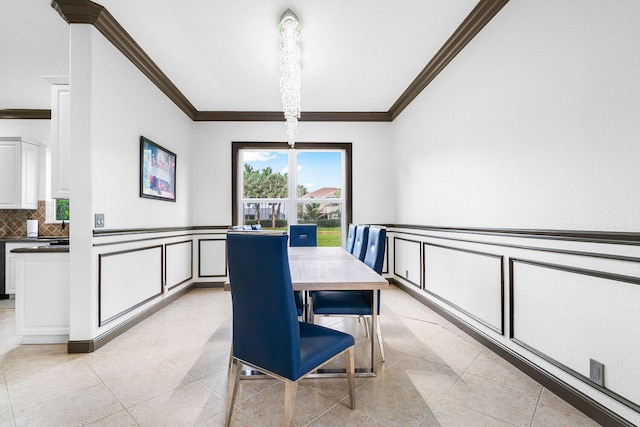 tiled dining room featuring ornamental molding