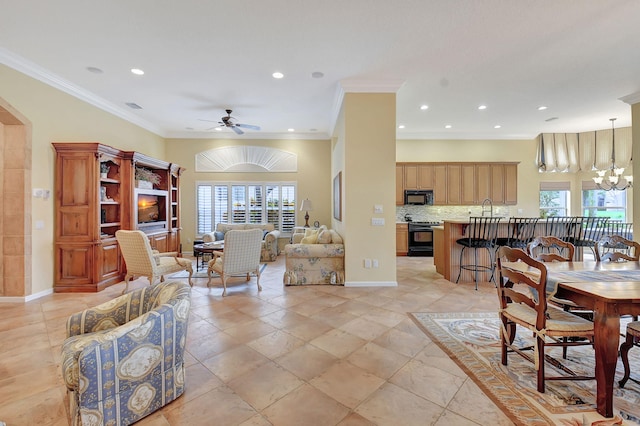 living room with ceiling fan with notable chandelier and crown molding