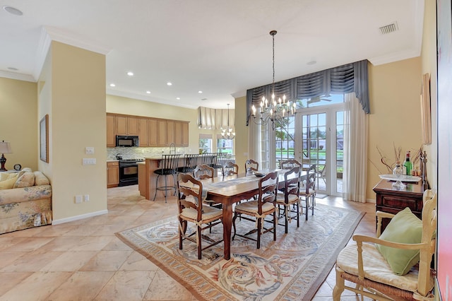 dining space featuring ornamental molding, a chandelier, and sink