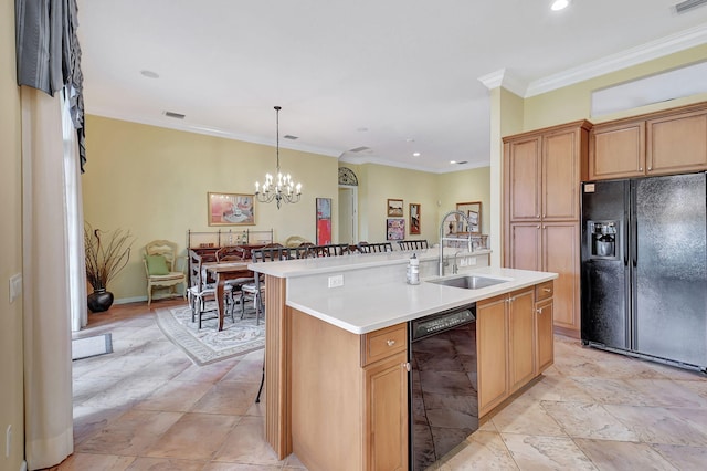 kitchen with an island with sink, hanging light fixtures, sink, black appliances, and an inviting chandelier