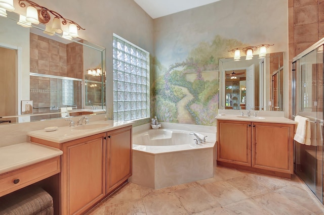 bathroom with vanity and shower with separate bathtub