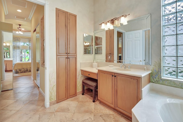 bathroom featuring ornamental molding, ceiling fan, a tub, and vanity