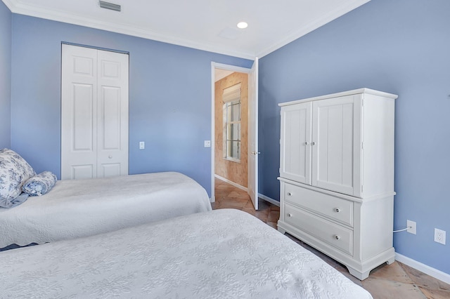 bedroom with ornamental molding and a closet