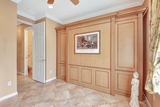 interior space with ornamental molding and ceiling fan