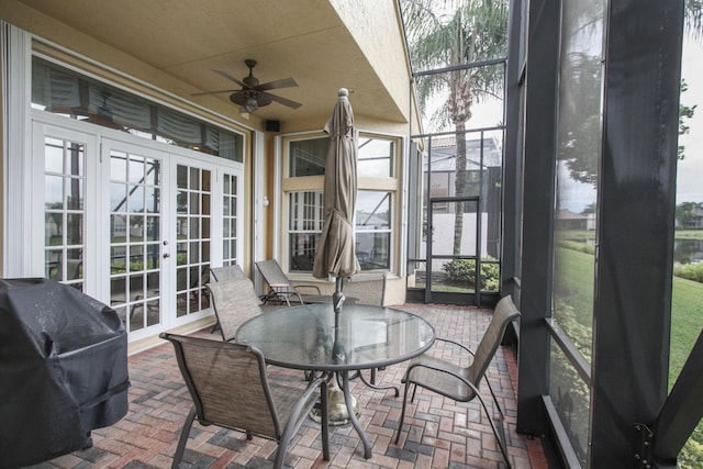 sunroom with ceiling fan and french doors