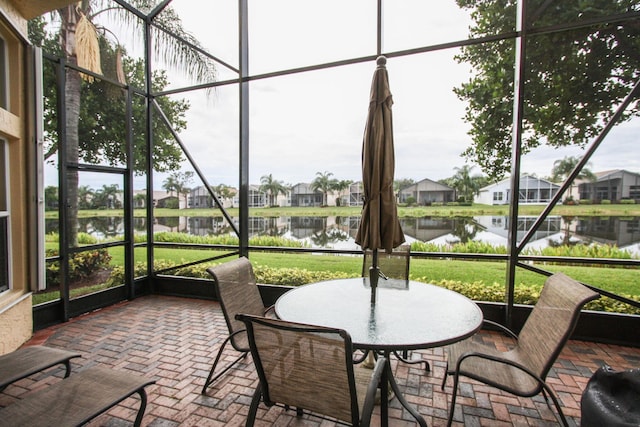 unfurnished sunroom with a water view and plenty of natural light