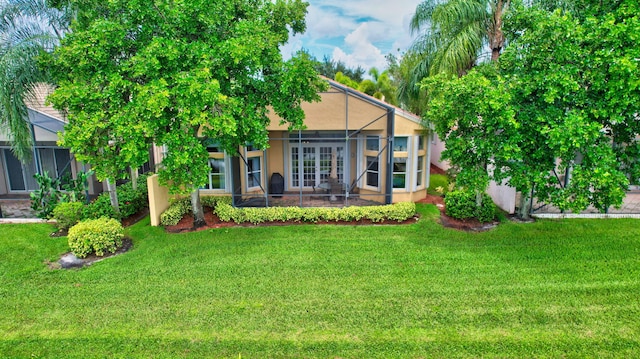 view of front of house with a front lawn and a lanai