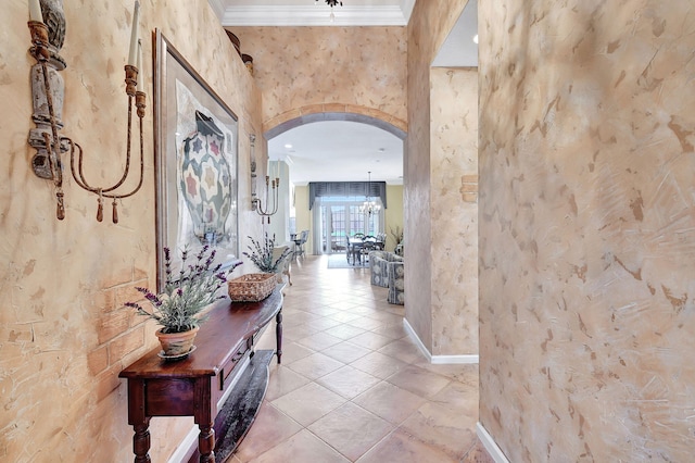 hall featuring ornamental molding and light tile patterned floors