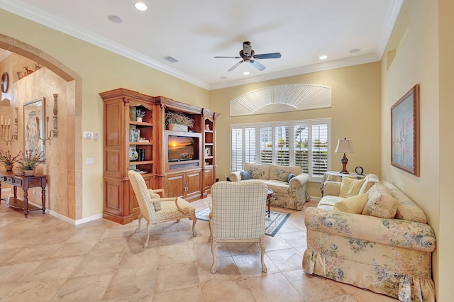 living room with ceiling fan and ornamental molding