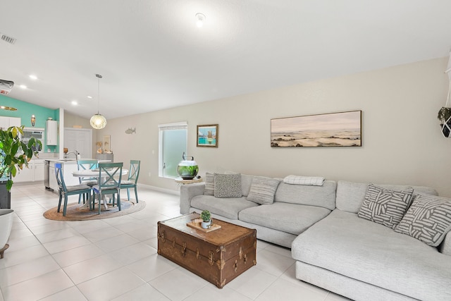 living room featuring light tile patterned floors and vaulted ceiling