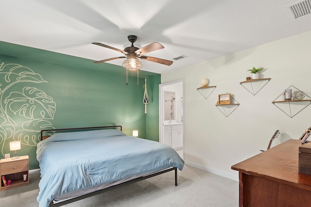 carpeted bedroom with connected bathroom and ceiling fan