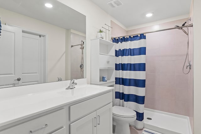 bathroom with walk in shower, vanity, and toilet