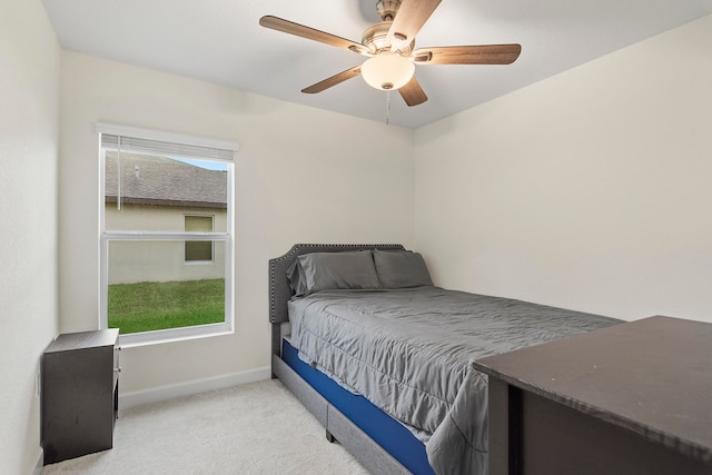 bedroom featuring light carpet, multiple windows, and ceiling fan