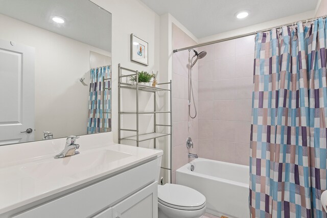 full bathroom featuring vanity, toilet, and shower / bathtub combination with curtain