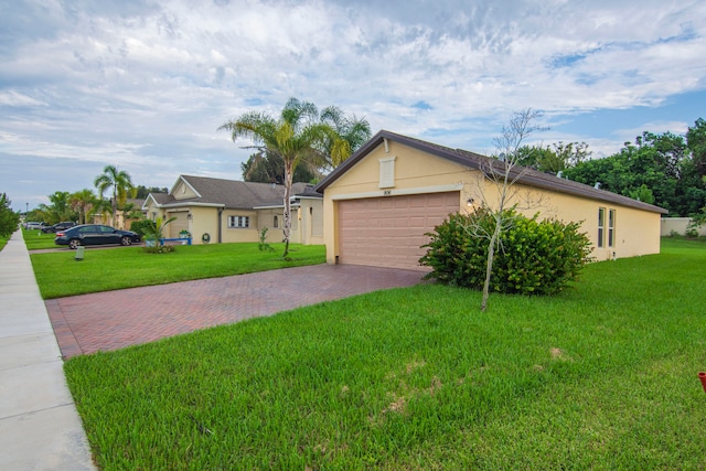 ranch-style home featuring a garage and a front lawn