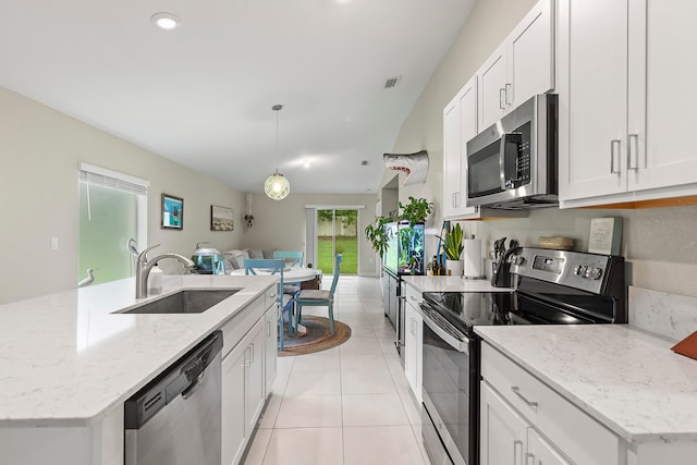 kitchen with white cabinets, appliances with stainless steel finishes, decorative light fixtures, and sink