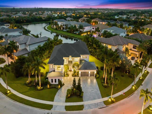 aerial view at dusk with a water view