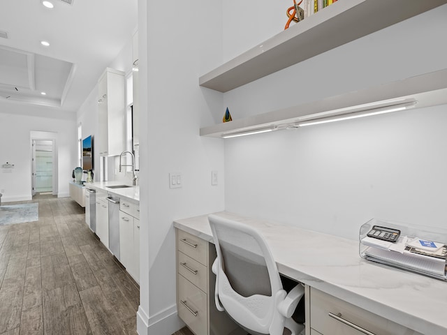 office with sink, dark wood-type flooring, and built in desk