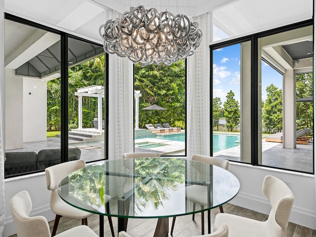 dining room featuring hardwood / wood-style flooring and an inviting chandelier