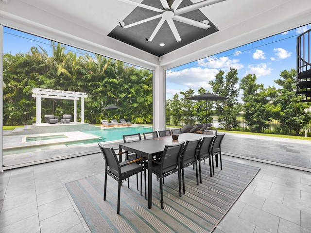 view of patio / terrace with ceiling fan and a pool with hot tub